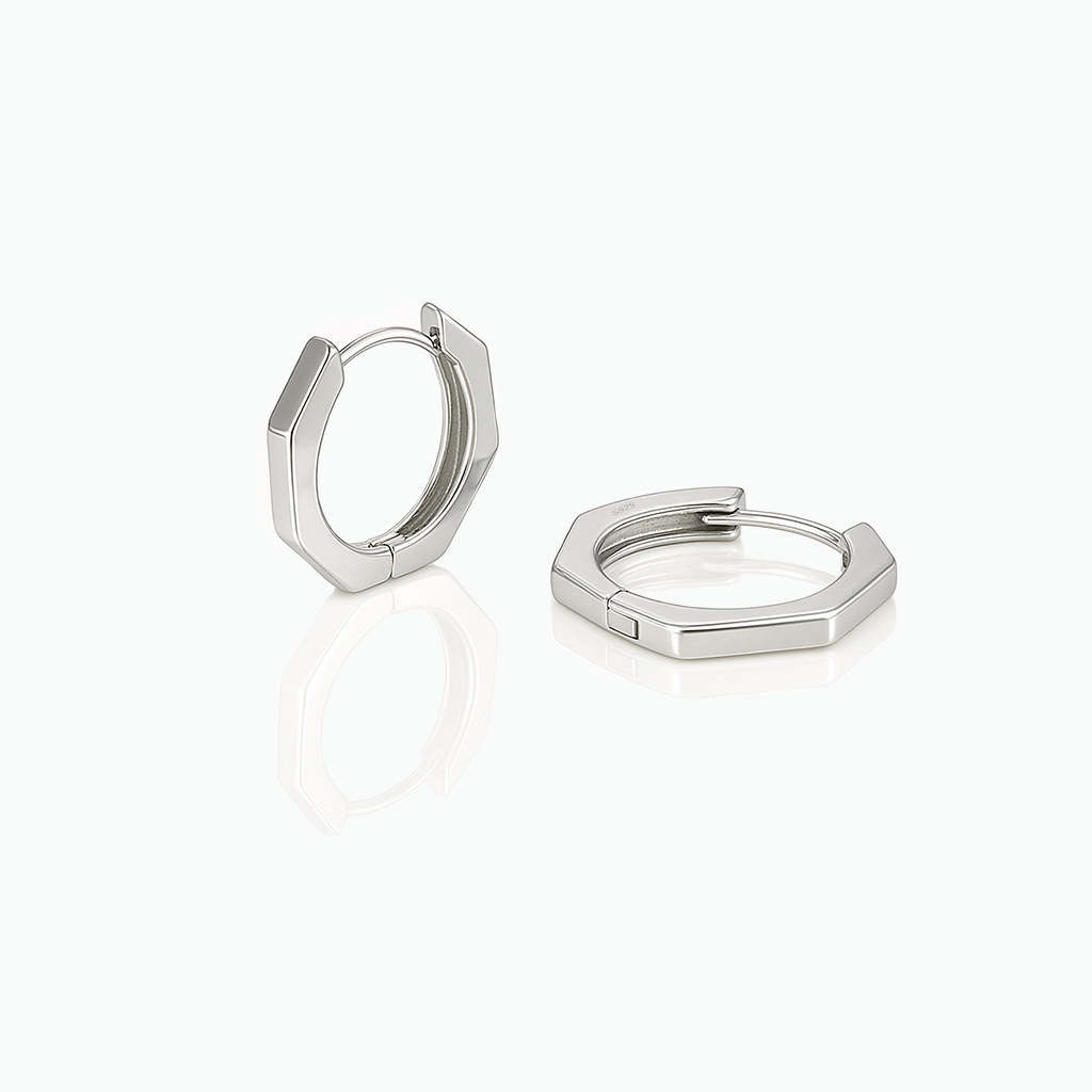A pair of minimalist hexagon huggie earrings in gold color, crafted from 925 sterling silver, displayed on a white background.