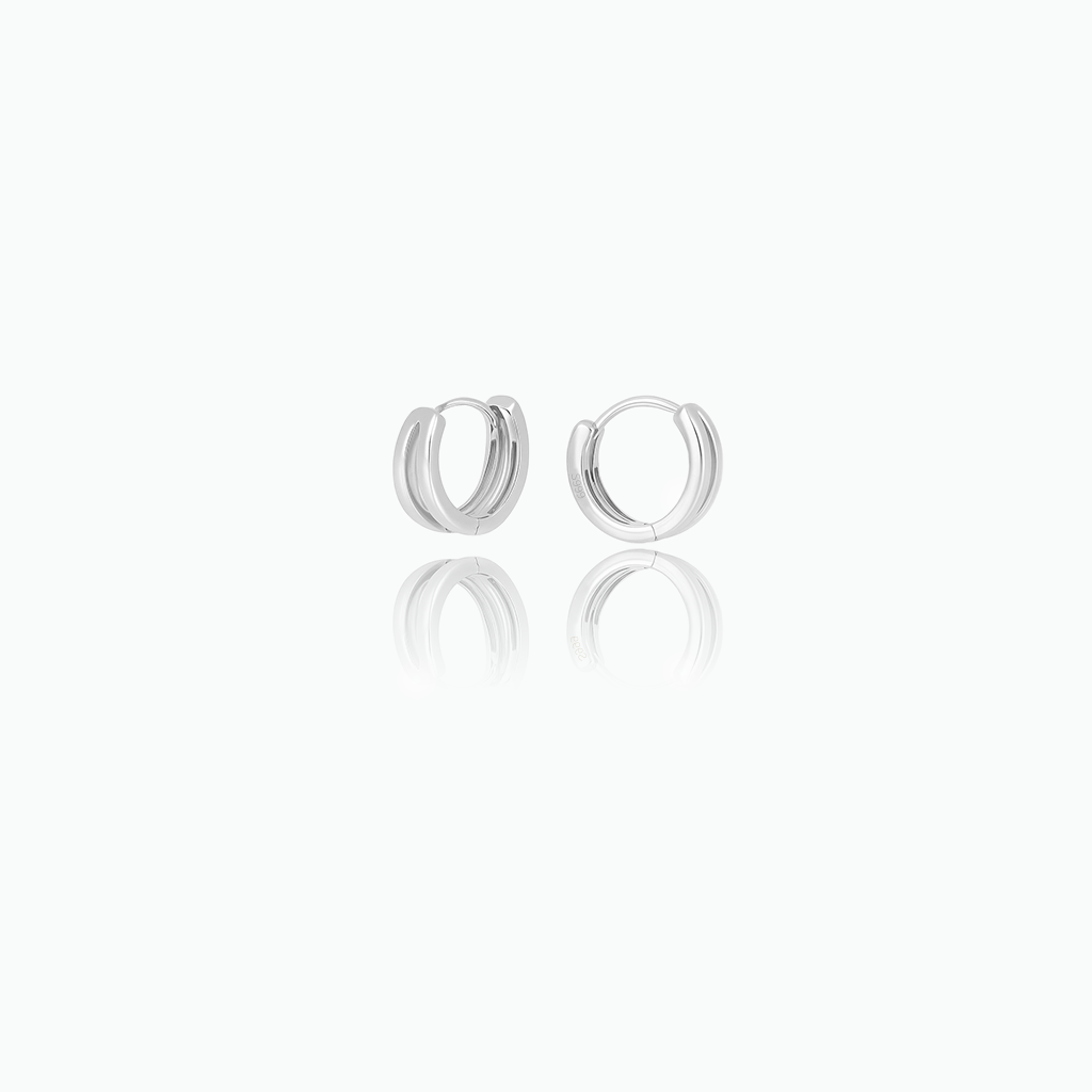 Pair of silver hoop earrings on a white background