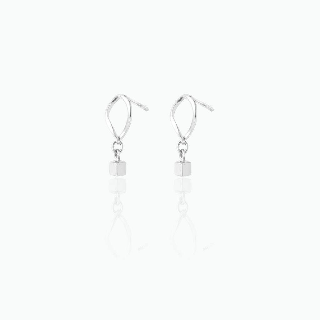 Silver earrings with small square beads on a white background