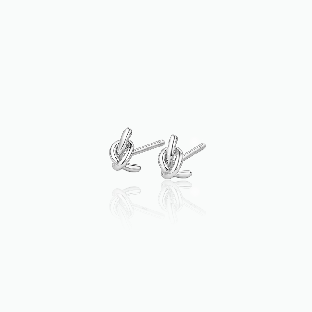 Silver knot earrings on a white background