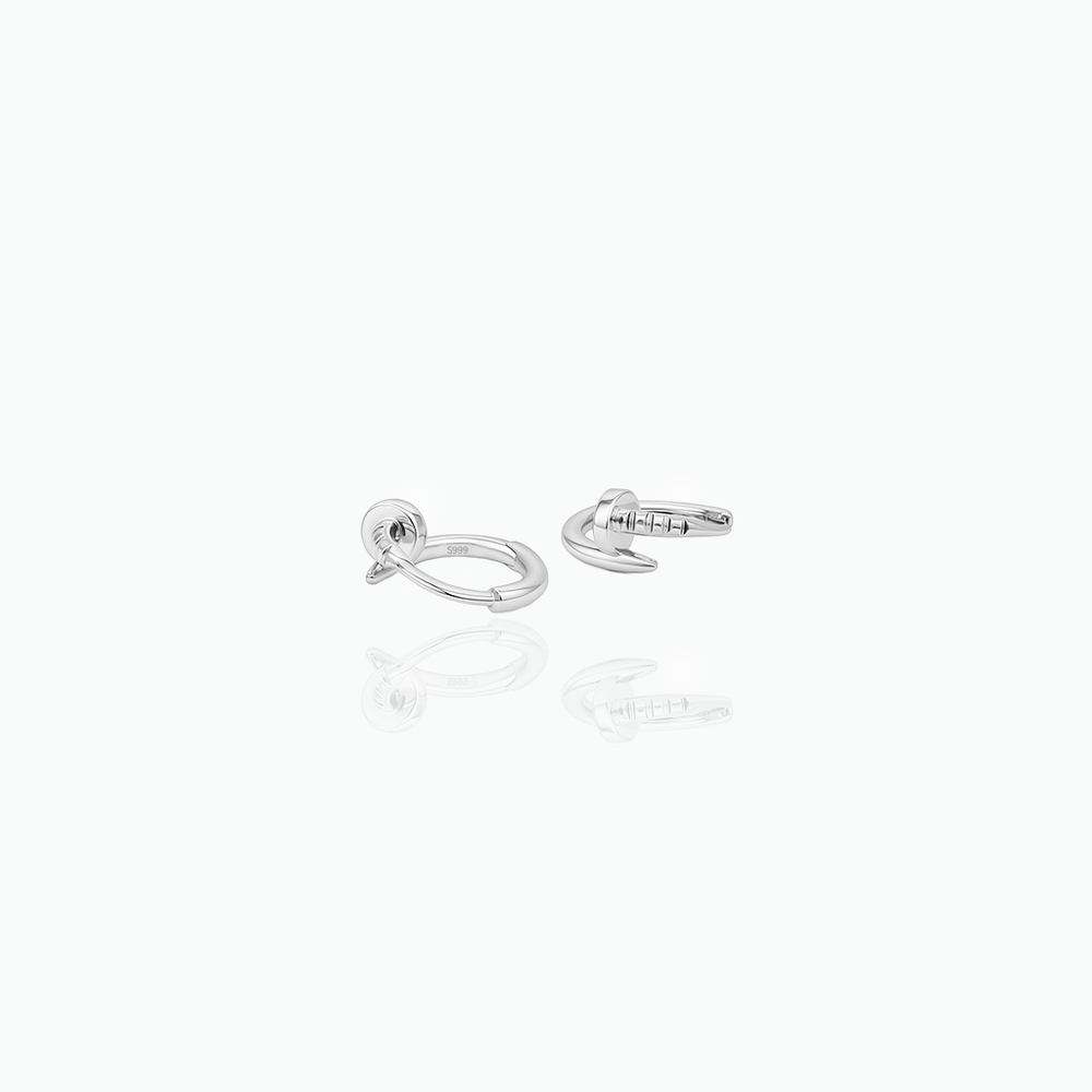 Silver earring on a white background