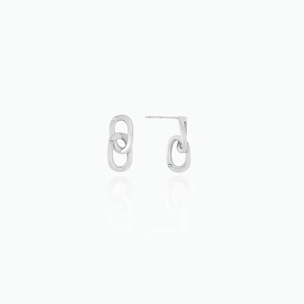 Pair of silver earrings on a white background
