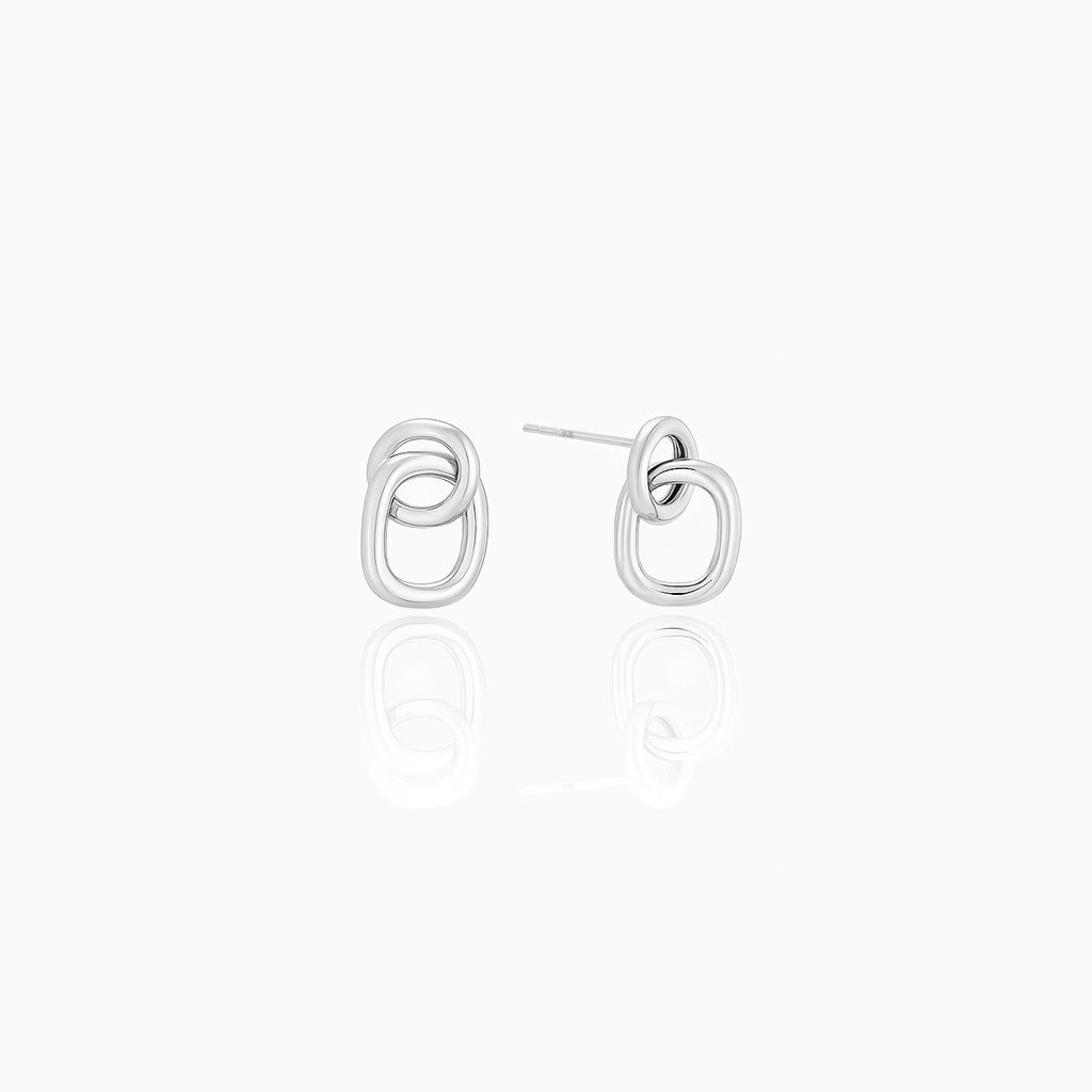 Pair of silver earrings on a white background