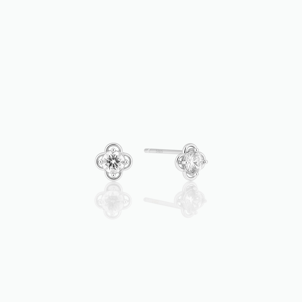 Pair of silver stud earrings on a white background