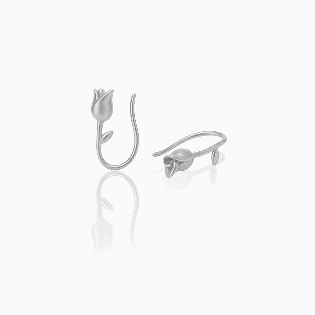 Silver tulip-shaped earrings on a white background