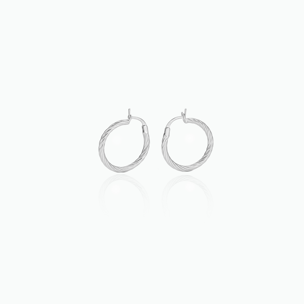 Pair of silver hoop earrings on a white background