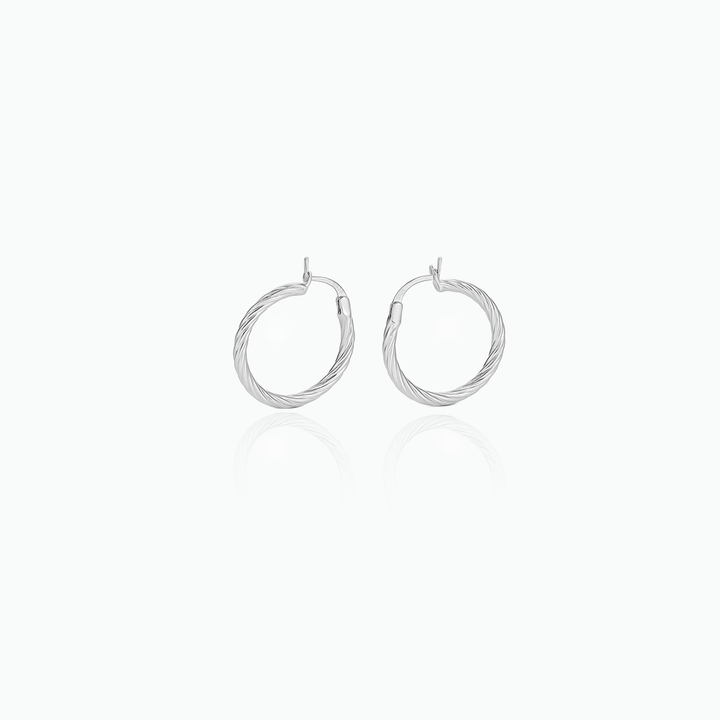 Pair of silver hoop earrings on a white background