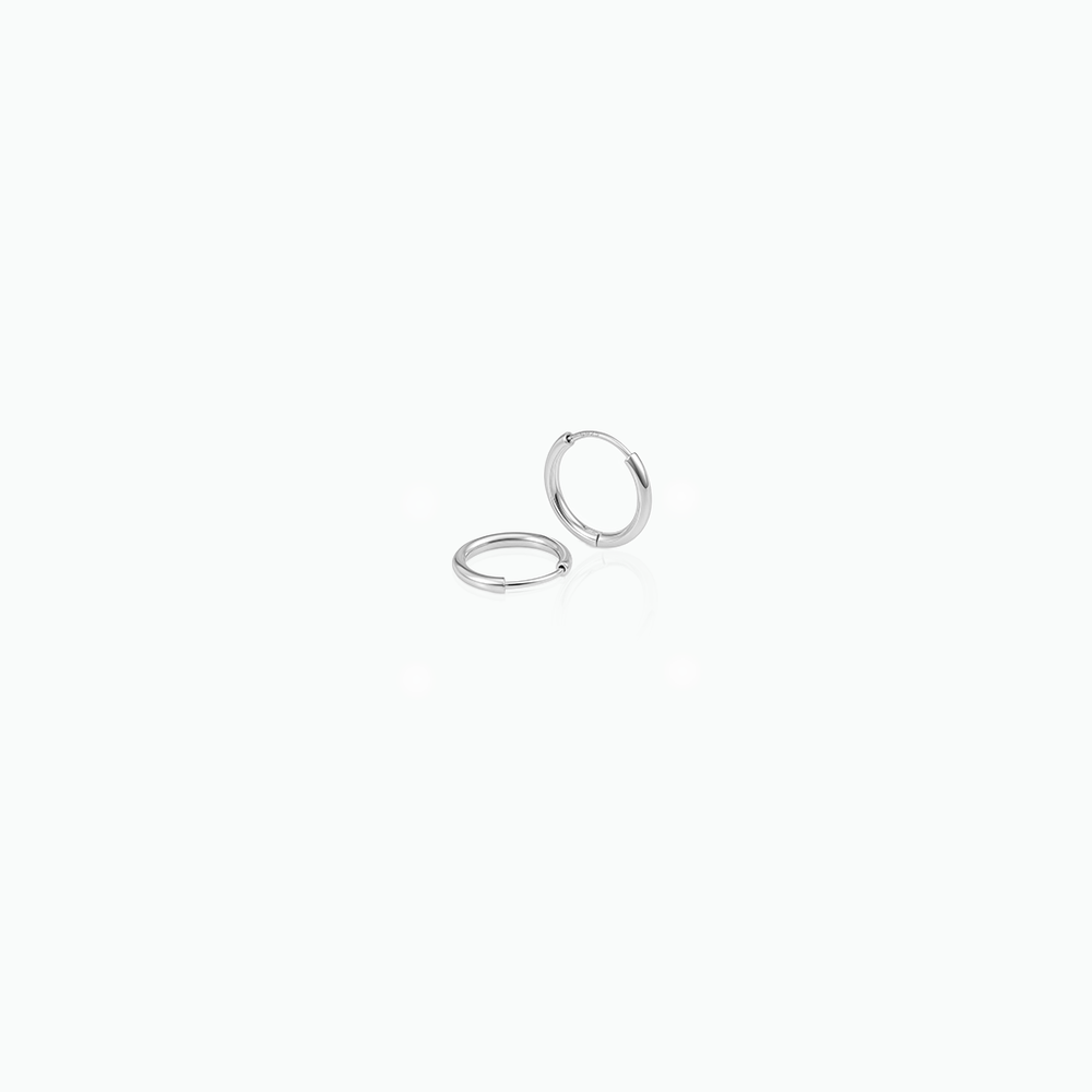 Pair of silver hoop earrings on a white background