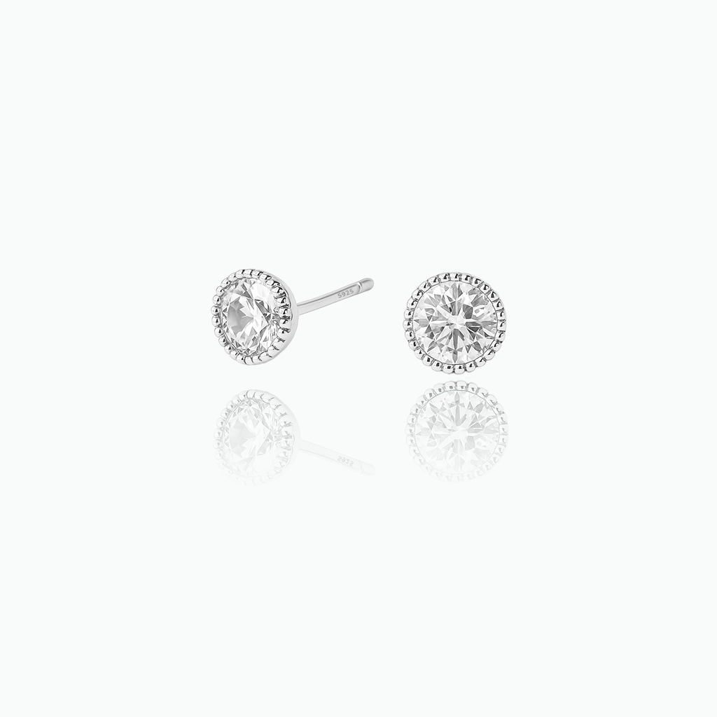 Pair of diamond stud earrings on a white background