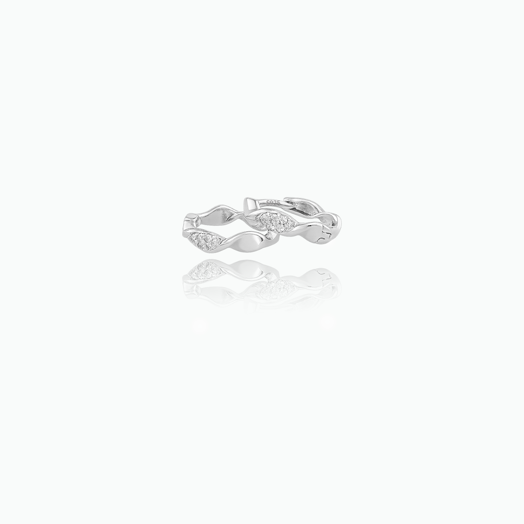 Silver ring with a diamond on a white background