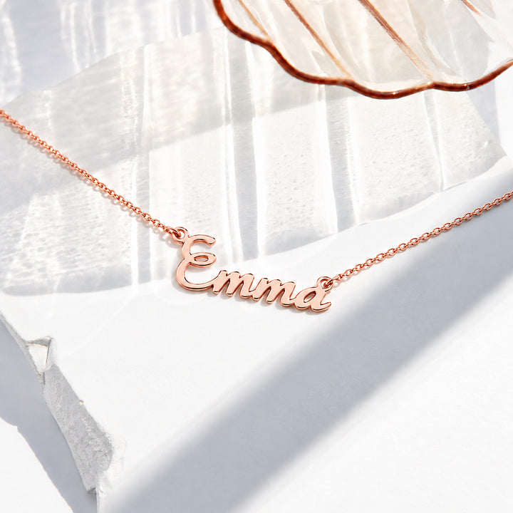 Rose gold finish personalized script name necklace reading Emma on a fine cable chain