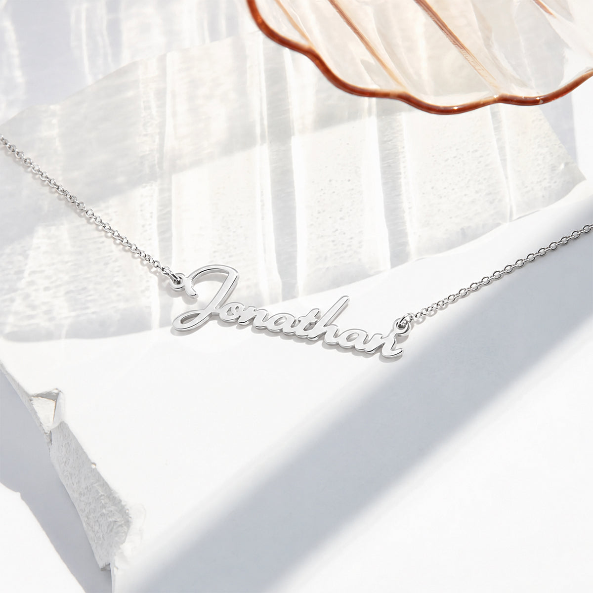 Silver finish personalized script name necklace reading Jonathan on a fine cable chain
