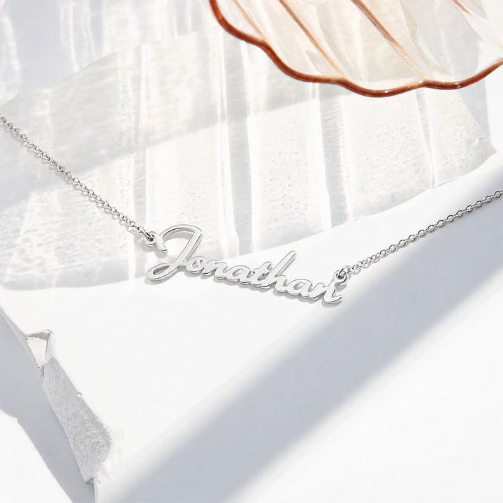 Silver finish personalized script name necklace reading Jonathan on a fine cable chain
