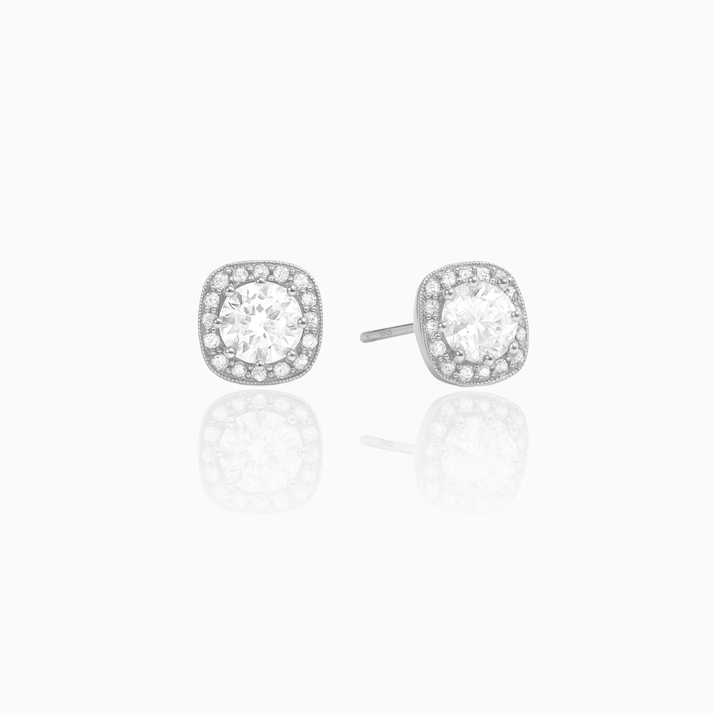 Pair of silver stud earrings with clear gemstones on a white background