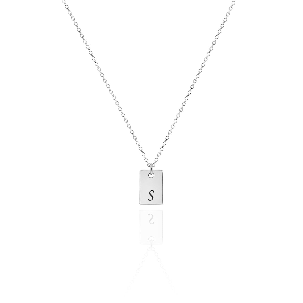 Silver-tone necklace with a rectangular tag pendant engraved with the letter S on a white background