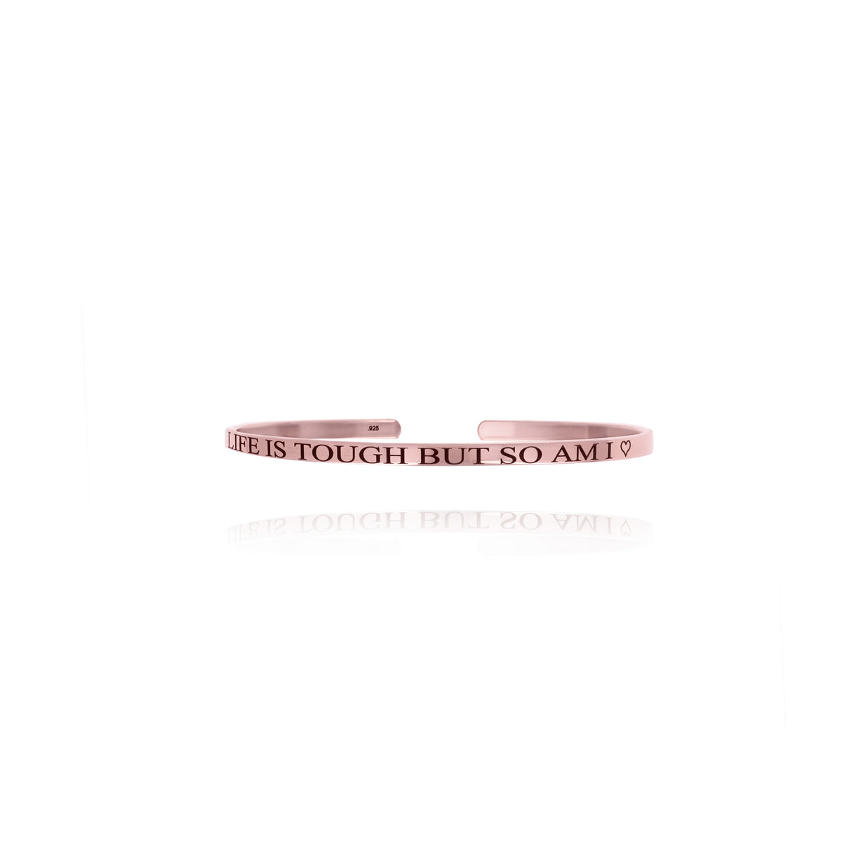 Rose-gold-tone cuff bracelet engraved LIFE IS TOUGH BUT SO AM I with a heart on a white background