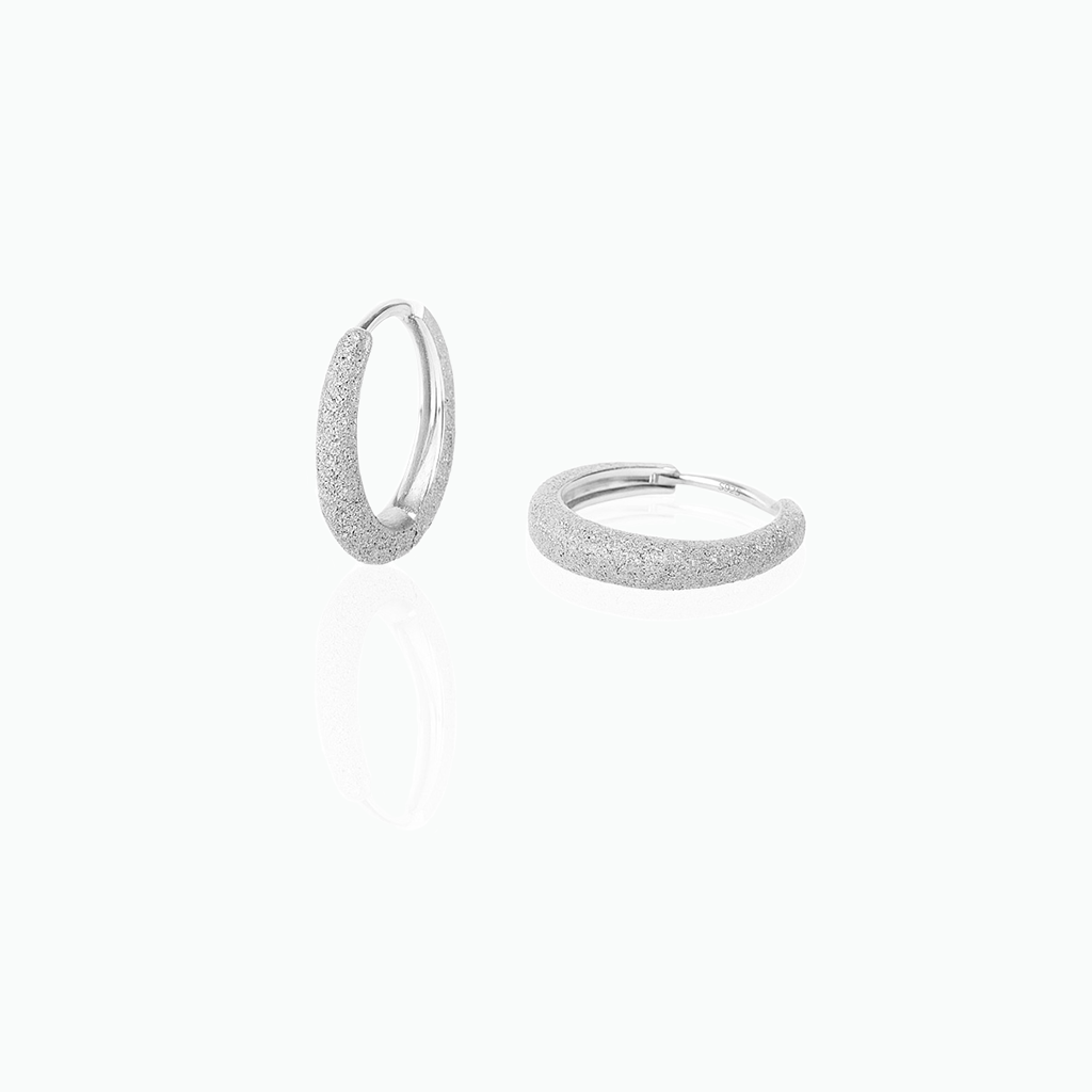 Silver hoop earrings on a white background