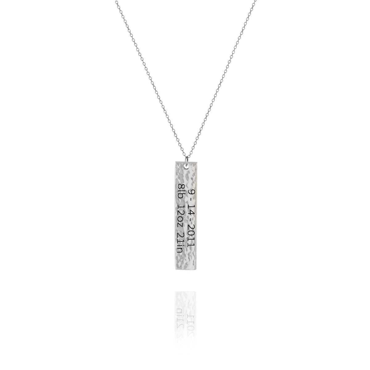 A personalized hammered vertical bar necklace in silver tone, with engraved text, displayed on a white background.