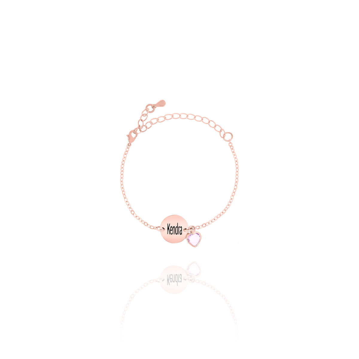 Rose-gold-tone bracelet with engraved Kendra disc and pale pink faceted stone charm on white background