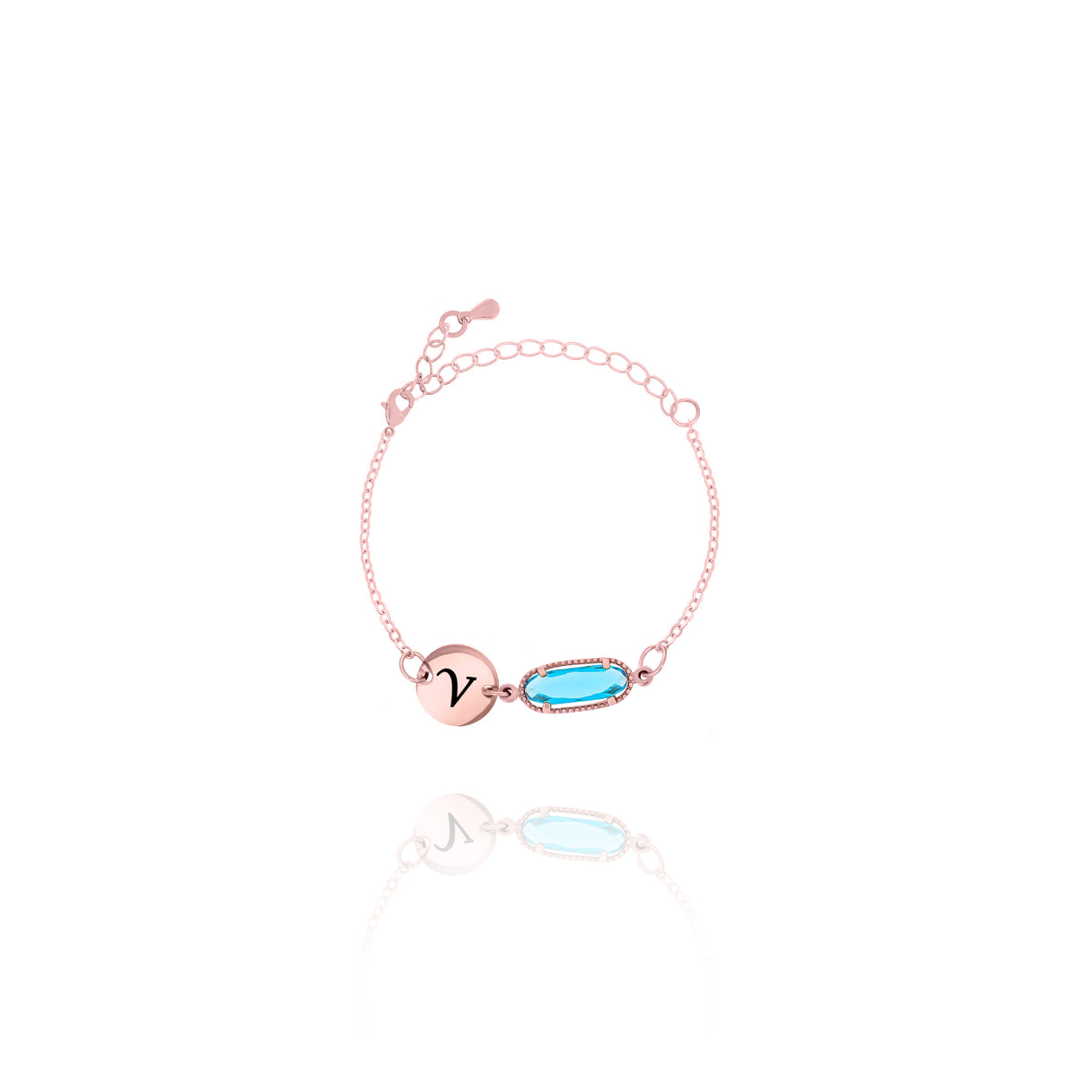Rose-gold-tone bracelet with engraved V initial disc and light blue faceted rectangular stone on white background