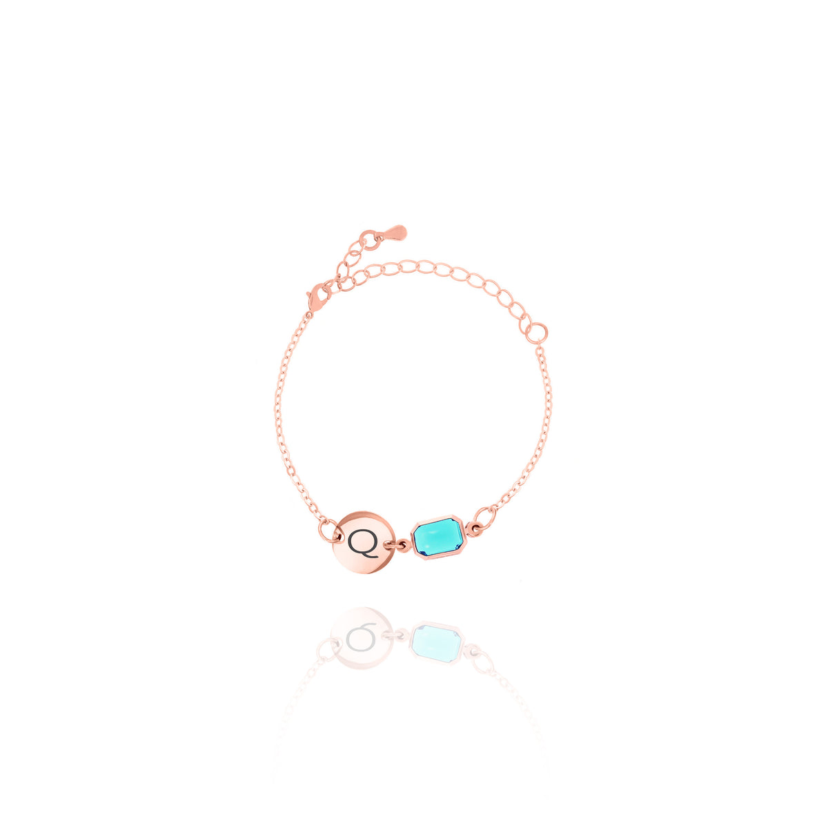 Rose-gold-tone bracelet with engraved Q initial disc and light blue rectangular stone on white background