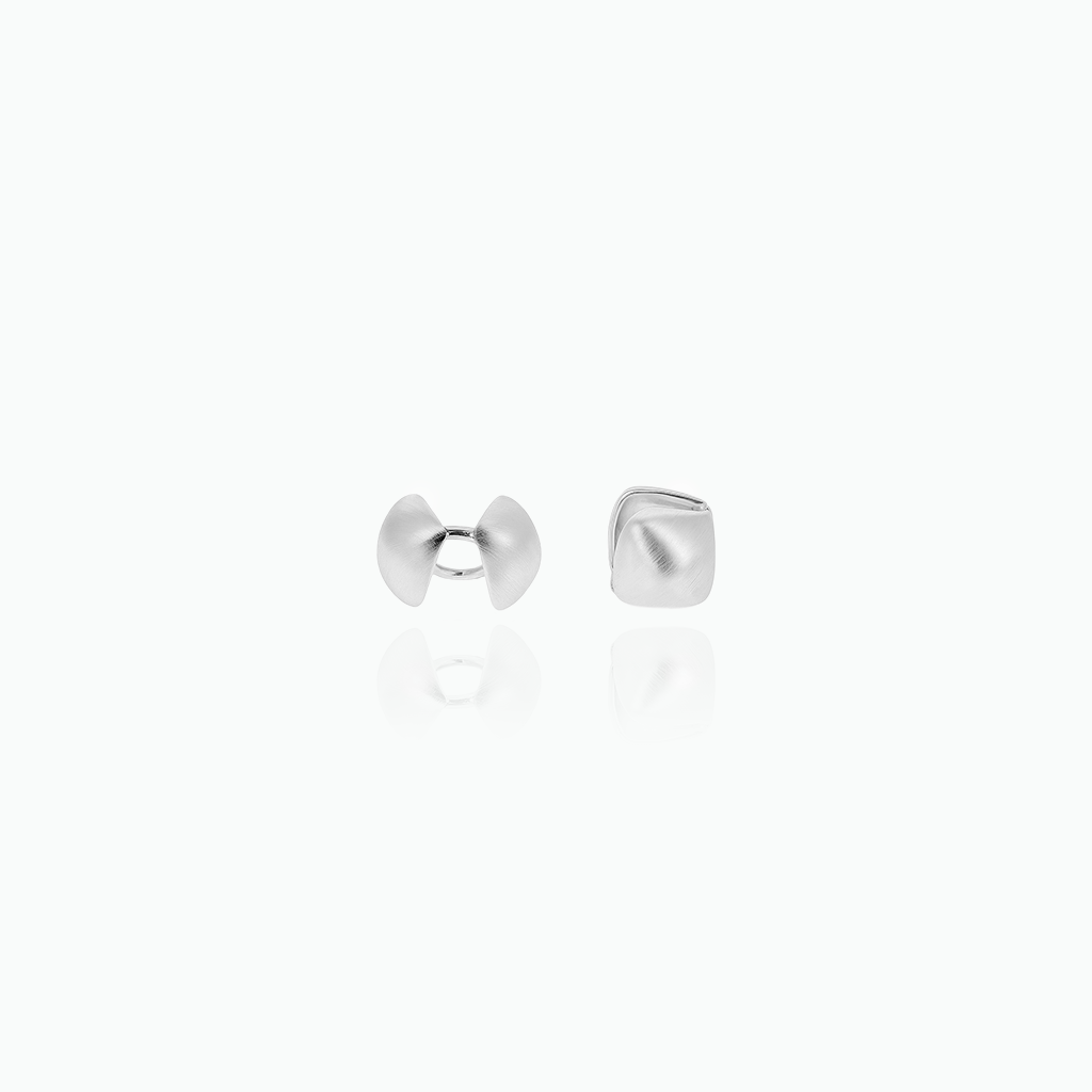 Pair of silver stud earrings on a white background